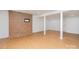Finished basement features a stylish accent brick wall and durable laminate flooring at 107 Grand Canyon Rd, Stanley, NC 28164