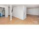 Finished basement features laminate flooring and access to utility area with water heater at 107 Grand Canyon Rd, Stanley, NC 28164