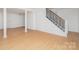 Finished basement has modern stairs with black metal balusters and durable laminate flooring at 107 Grand Canyon Rd, Stanley, NC 28164