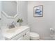 Cozy bathroom features framed art, a toilet, and a white vanity sink at 107 Grand Canyon Rd, Stanley, NC 28164