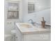 Bright bathroom featuring marble sink, vanity, and toilet, plus a window and gold fixtures at 107 Grand Canyon Rd, Stanley, NC 28164