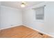 Empty bedroom with hardwood floors, overhead lighting, and a single window at 107 Grand Canyon Rd, Stanley, NC 28164