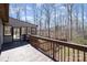 Wide wooden deck offering panoramic views of a lush, tree-filled backyard at 107 Grand Canyon Rd, Stanley, NC 28164