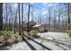 Spacious driveway leading to a two-car garage, surrounded by lush greenery at 107 Grand Canyon Rd, Stanley, NC 28164