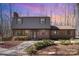 Charming brick home featuring manicured landscaping and a welcoming entrance under a colorful sky at 107 Grand Canyon Rd, Stanley, NC 28164