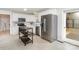 Bright kitchen featuring white cabinets, stainless steel refrigerator, and tile flooring at 107 Grand Canyon Rd, Stanley, NC 28164