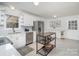 Bright kitchen featuring white cabinetry, stainless steel appliances, and tile flooring at 107 Grand Canyon Rd, Stanley, NC 28164