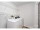 Functional laundry room featuring a washer and dryer, along with wire shelving at 107 Grand Canyon Rd, Stanley, NC 28164