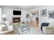 Living room with fireplace, mantle, and hardwood floors and view to dining room at 107 Grand Canyon Rd, Stanley, NC 28164