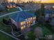 Breathtaking aerial view of the brick home with balcony, manicured lawn and lush greenery at 110 49Th Avenue Nw Pl, Hickory, NC 28601