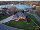 Stunning aerial view of the brick home with lake views, lush greenery, and neighborhood charm at 110 49Th Avenue Nw Pl, Hickory, NC 28601