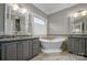 Luxurious bathroom with a freestanding tub, double vanities, and elegant tile work at 110 49Th Avenue Nw Pl, Hickory, NC 28601