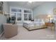 Comfortable bedroom offers large windows and a sitting area with a desk at 110 49Th Avenue Nw Pl, Hickory, NC 28601