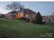 Charming brick home showcasing manicured lawn, mature trees, and well maintained landscaping at 110 49Th Avenue Nw Pl, Hickory, NC 28601