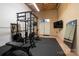 Spacious home gym includes workout equipment, mirrors, rubber flooring, and a mounted television at 110 49Th Avenue Nw Pl, Hickory, NC 28601