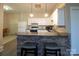 Well-lit kitchen features white cabinetry, granite countertops, stainless steel appliances, and barstool seating at 110 49Th Avenue Nw Pl, Hickory, NC 28601