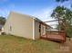 A well-maintained backyard featuring a wooden deck and mature trees at 1144 Amberlight Cir, Salisbury, NC 28144