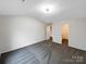 Neutral bedroom with plush carpet, light fixture, and convenient access to the ensuite bathroom at 1144 Amberlight Cir, Salisbury, NC 28144