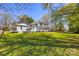 A well maintained green backyard and a view of the white two story home at 121 N Congress St, York, SC 29745