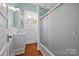Bright bathroom with a white vanity, wood floor, and a frosted glass shower enclosure at 121 N Congress St, York, SC 29745