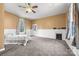 Spacious bedroom featuring a fireplace, ceiling fan and plush carpet at 121 N Congress St, York, SC 29745