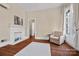 Bedroom features hardwood floors, fireplace, large windows, and natural light at 121 N Congress St, York, SC 29745