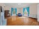 Sun-filled bedroom features hardwood floors, bright curtains, and a decorative fireplace at 121 N Congress St, York, SC 29745