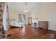 Primary bedroom featuring hardwood floors, a decorative fireplace, and large windows at 121 N Congress St, York, SC 29745