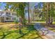 The long gravel driveway approaches a classic two-story home on a verdant lot at 121 N Congress St, York, SC 29745