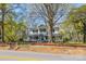 Charming two-story home with a large front porch surrounded by mature trees at 121 N Congress St, York, SC 29745