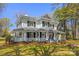 Classic home featuring a wrap-around porch, green shutters, and mature landscaping, exuding Southern charm and elegance at 121 N Congress St, York, SC 29745