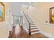 Bright foyer featuring staircase with chandelier and hardwood flooring at 121 N Congress St, York, SC 29745