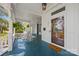 Welcoming front porch with rocking chairs, a 'Welcome' mat, and a traditional wooden door with an American flag reflecting at 121 N Congress St, York, SC 29745