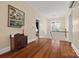 Hallway with hardwood floors, a small window, an antique cabinet, and views of the stairwell at 121 N Congress St, York, SC 29745