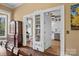 View of a beautifully appointed kitchen from the dining room, featuring stainless steel appliances and white cabinetry at 121 N Congress St, York, SC 29745