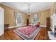 Classic living room with hardwood floors, tall windows, and a traditional fireplace, showcasing timeless elegance and warmth at 121 N Congress St, York, SC 29745