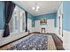 Living room with blue walls, a decorative fireplace, and a large window with natural light at 121 N Congress St, York, SC 29745