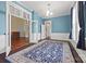 Spacious living room with blue walls, hardwood floors, and large openings to other rooms at 121 N Congress St, York, SC 29745