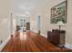 Living room with wood floors, neutral walls, a chandelier, and many windows at 121 N Congress St, York, SC 29745