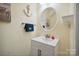 Cozy bathroom featuring white vanity, framed mirror, and beach decor at 1219 Catawba Run Rd, Lowell, NC 28098