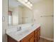 Bathroom featuring double sinks, a large mirror, and cherry wood cabinets at 1219 Catawba Run Rd, Lowell, NC 28098