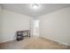 Empty room with neutral carpet and walls, as well as a dark colored table at 1219 Catawba Run Rd, Lowell, NC 28098