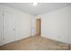 An empty room with white walls and neutral carpet at 1219 Catawba Run Rd, Lowell, NC 28098