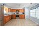 Bright kitchen features stainless steel appliances, tile floors, wooden cabinets, and a sunny window at 1219 Catawba Run Rd, Lowell, NC 28098