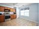Efficient kitchen space features stainless steel appliances, tiled flooring, and a cozy window at 1219 Catawba Run Rd, Lowell, NC 28098