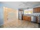 Open kitchen with stainless steel appliances, tiled floors, and seamless flow into the staircase at 1219 Catawba Run Rd, Lowell, NC 28098