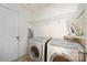 Well-organized laundry room featuring Bosch washer and dryer and storage shelving at 1219 Catawba Run Rd, Lowell, NC 28098