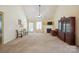 Spacious living room with high ceilings, fireplace, ceiling fan, and doors to a patio, perfect for entertaining at 1219 Catawba Run Rd, Lowell, NC 28098