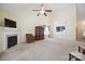 Expansive living room with fireplace, ceiling fan, and clear view to the kitchen, great for gatherings at 1219 Catawba Run Rd, Lowell, NC 28098
