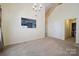 Bright living room featuring neutral carpet and open access to another room at 1219 Catawba Run Rd, Lowell, NC 28098